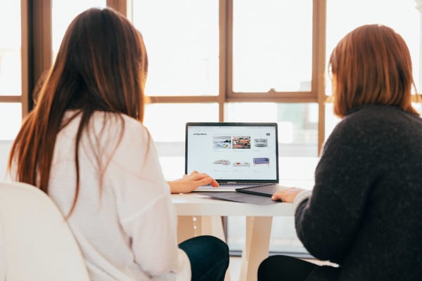 two colleagues reviewing marketing management framework